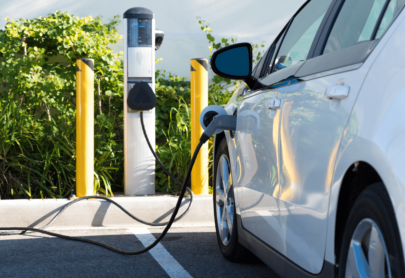 car using electric charger in parking lot